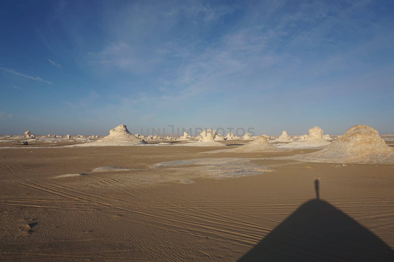 Small shade of a person on a hill in the white desert, Egypt
