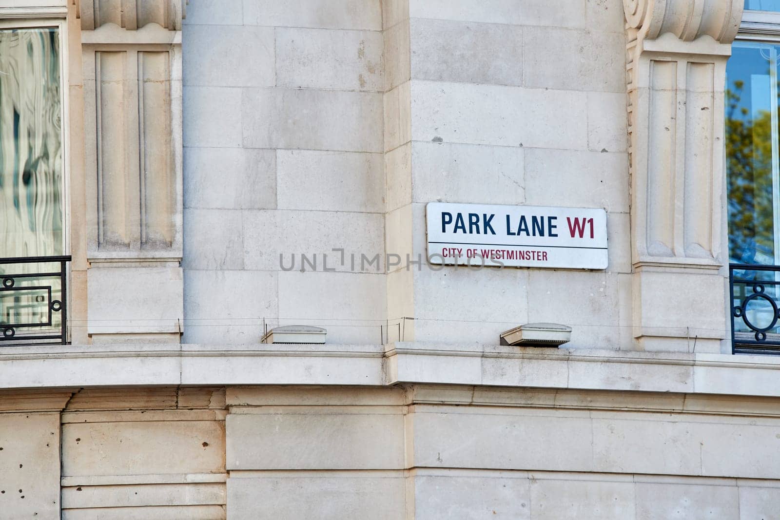Detail of Park Lane street sign on empty building wall.