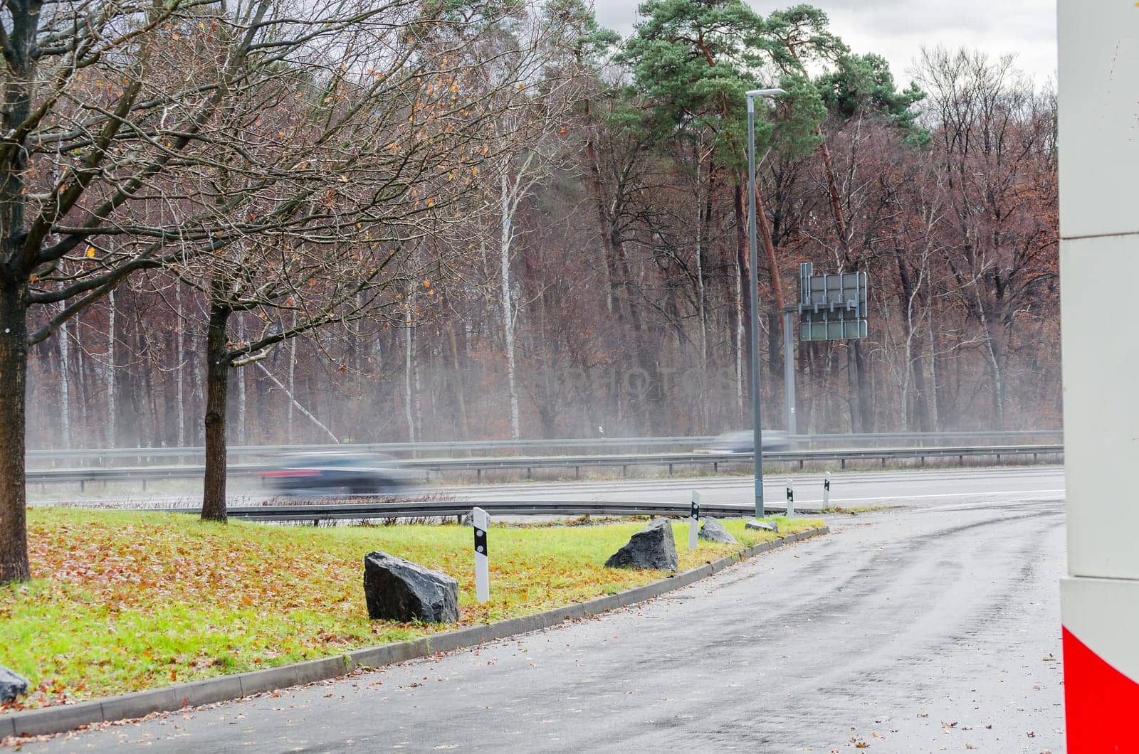 View from a parking lot to a highway in heavy rain.
