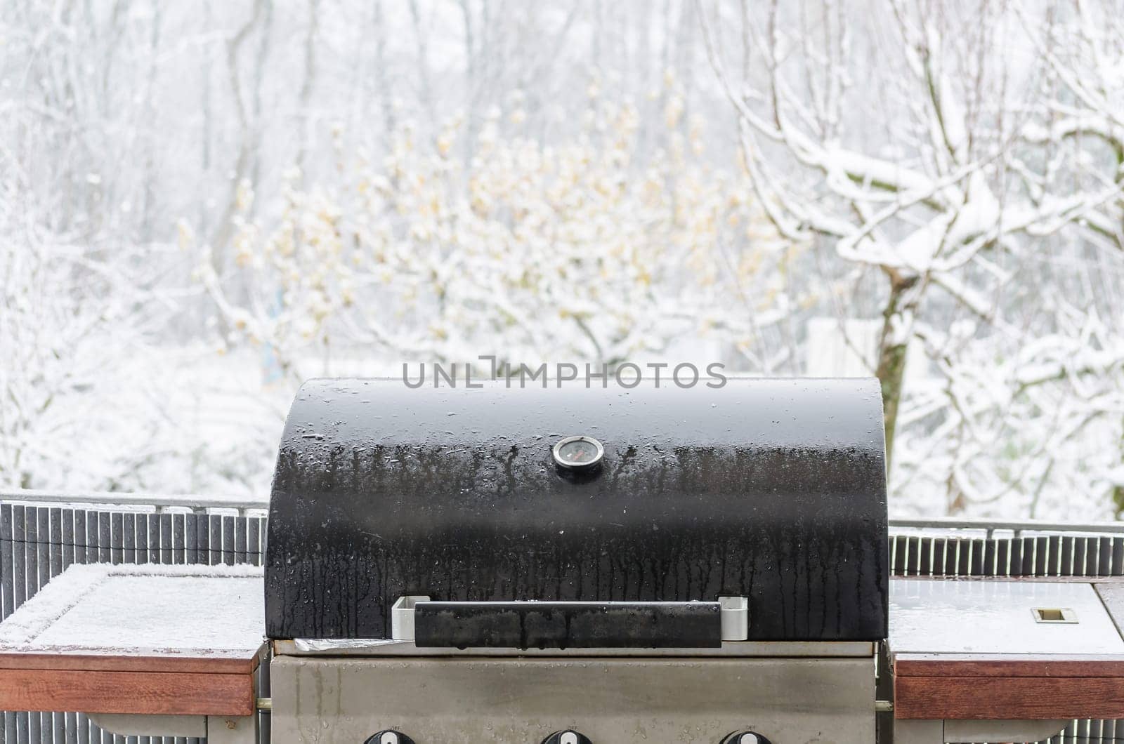 Barbecue Grill in winter on a balcony ready for winter grilling.