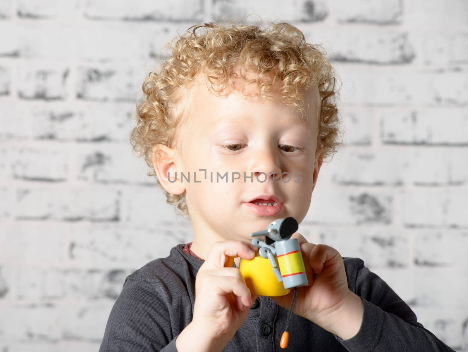 a little child plays with toys animals