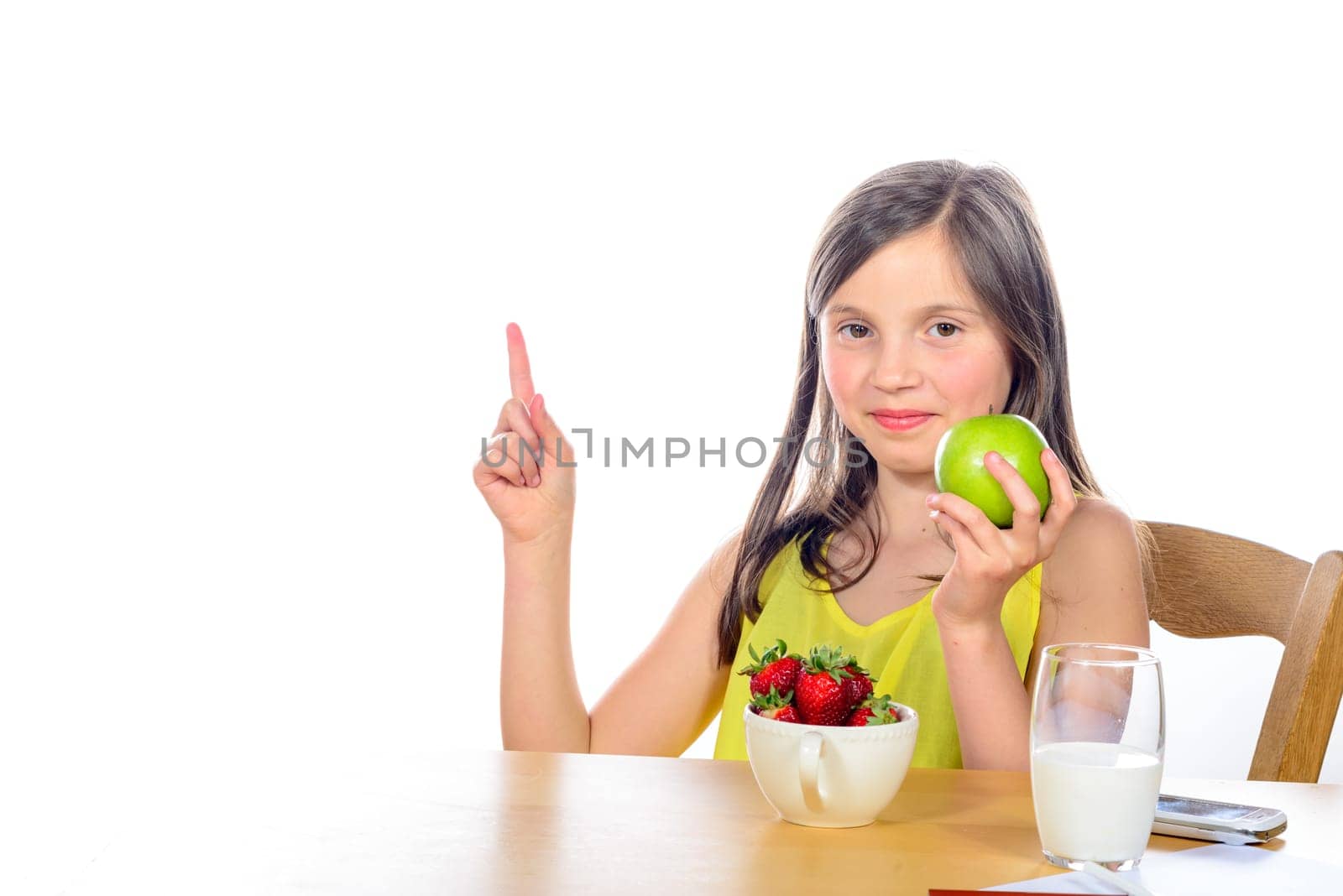 a little girl raises his hand to school with apple