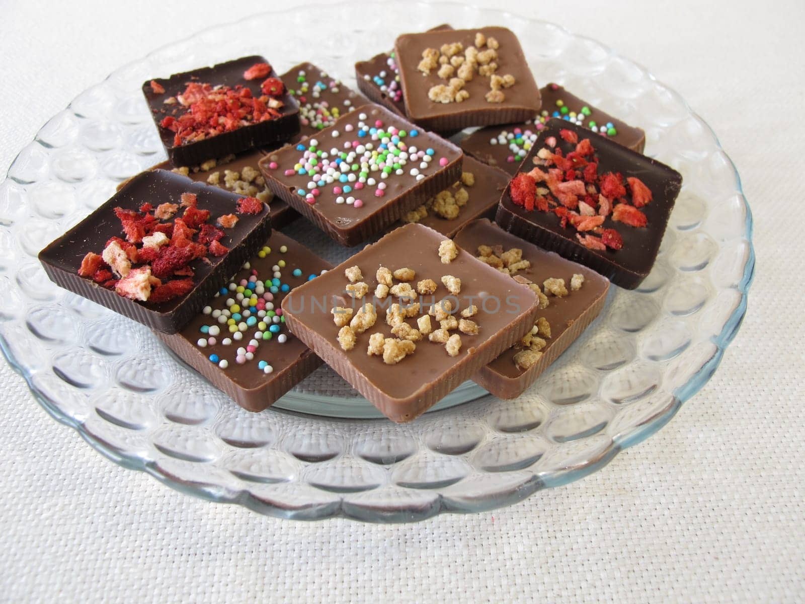 Various homemade chocolate pieces on a glass plate