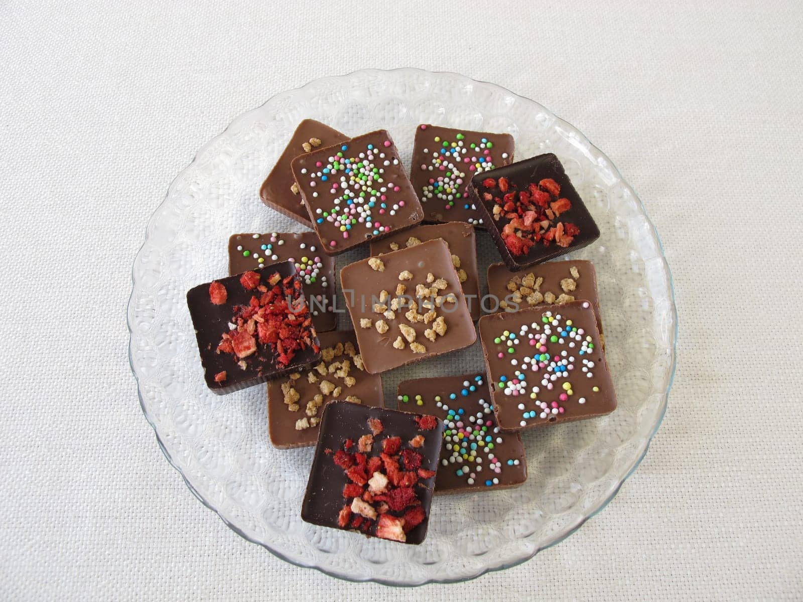 Various homemade chocolate pieces on a glass plate
