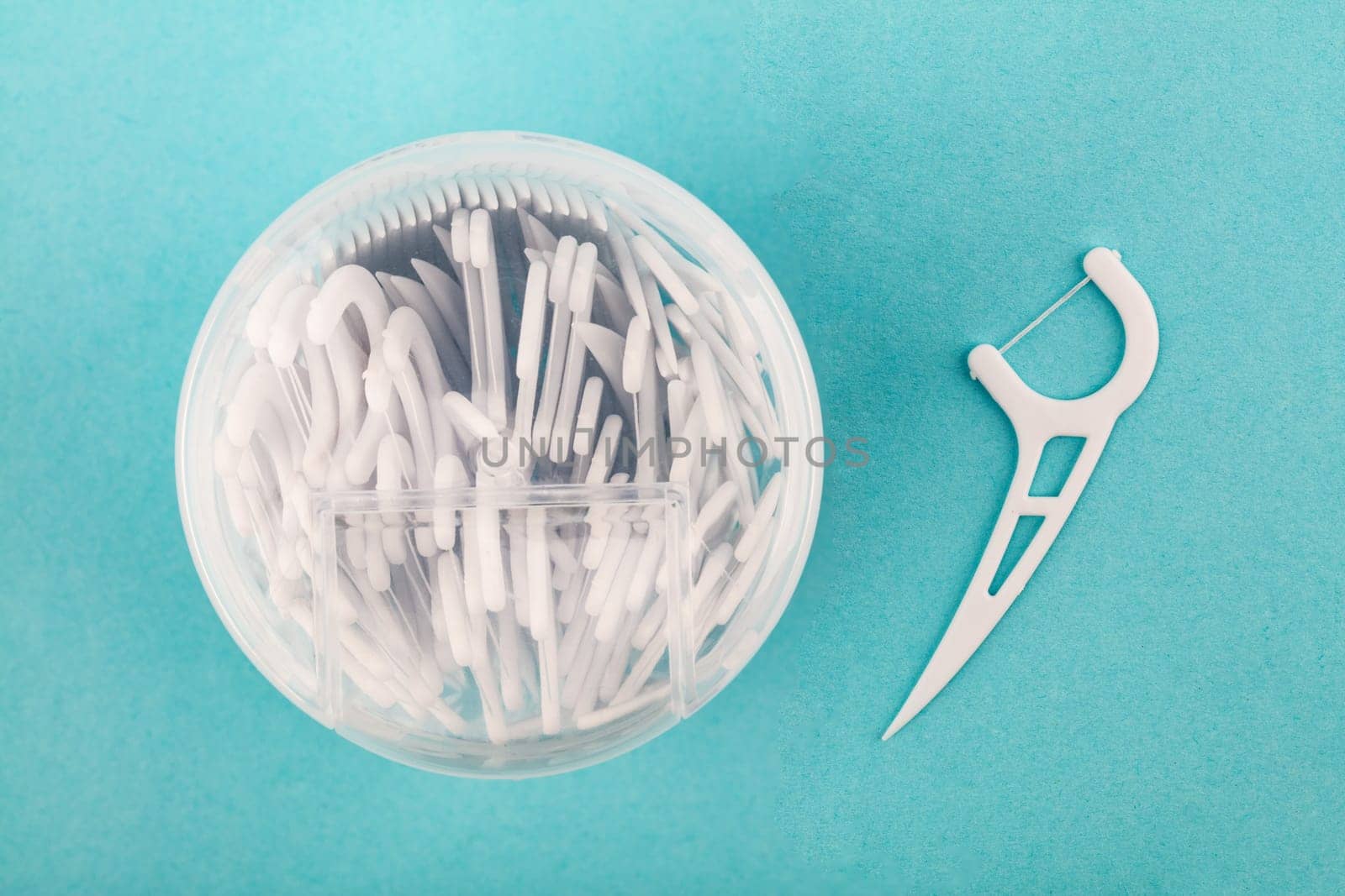 Box with dental Floss over light blue background
