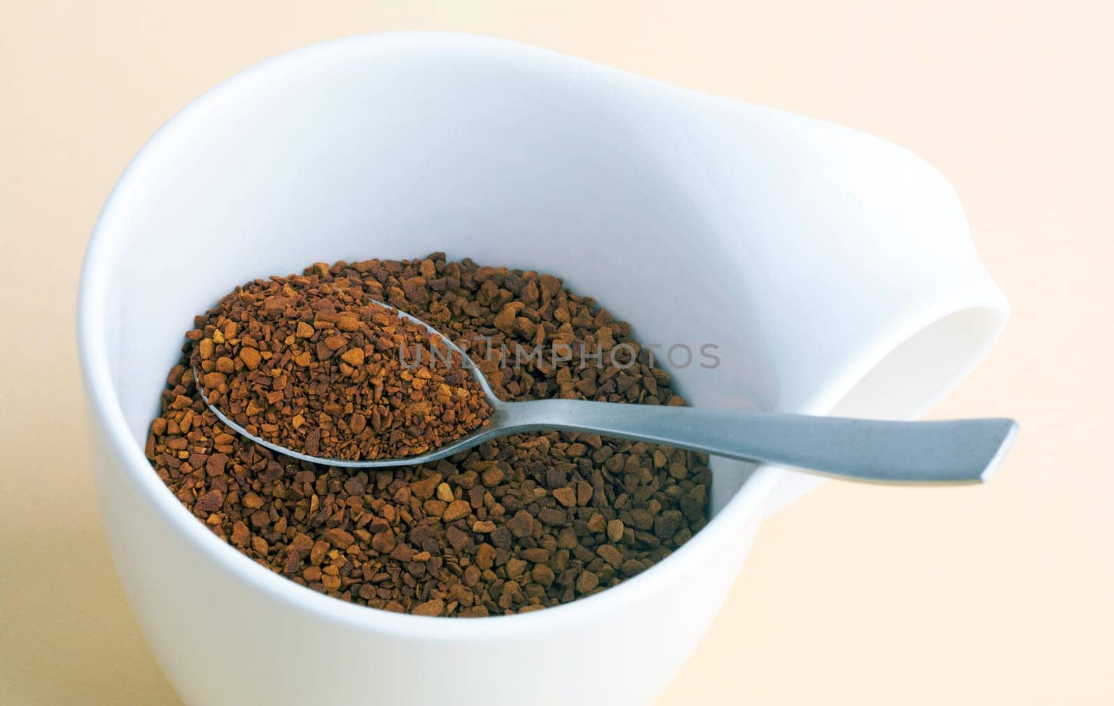 Powdered Coffee in a white cup over bright background
