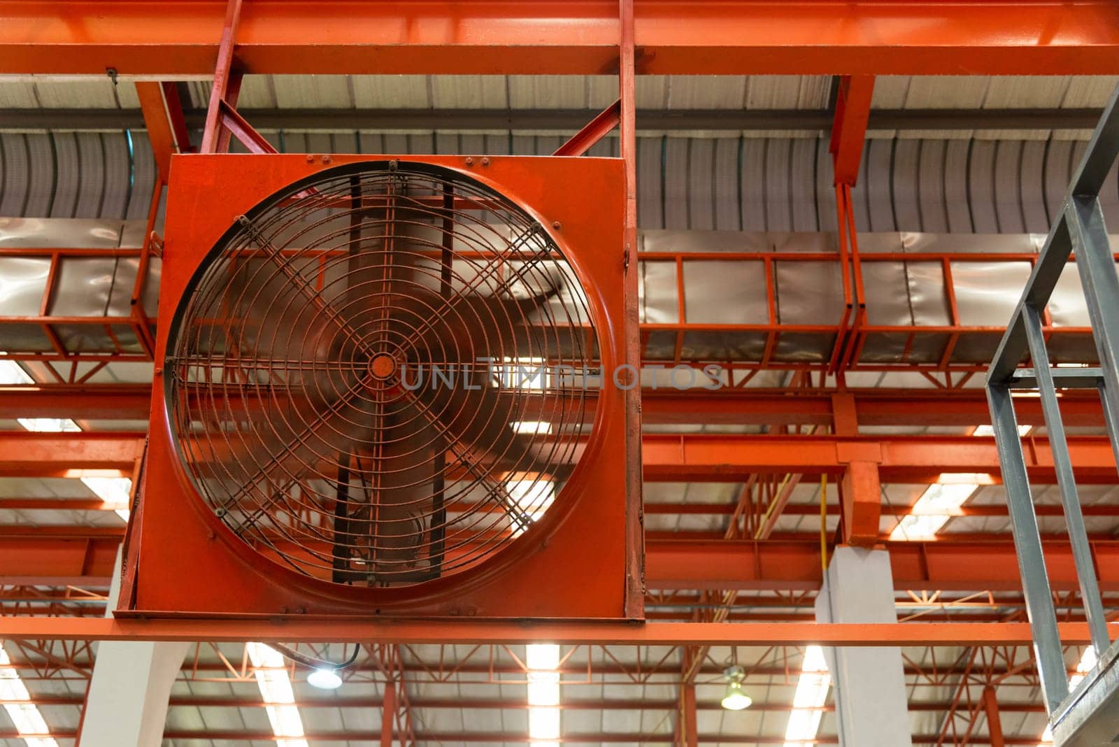 Big industrial cooler red fans in factory for reduced heat in operation ventilation of plant, industry cooling mechanical fan