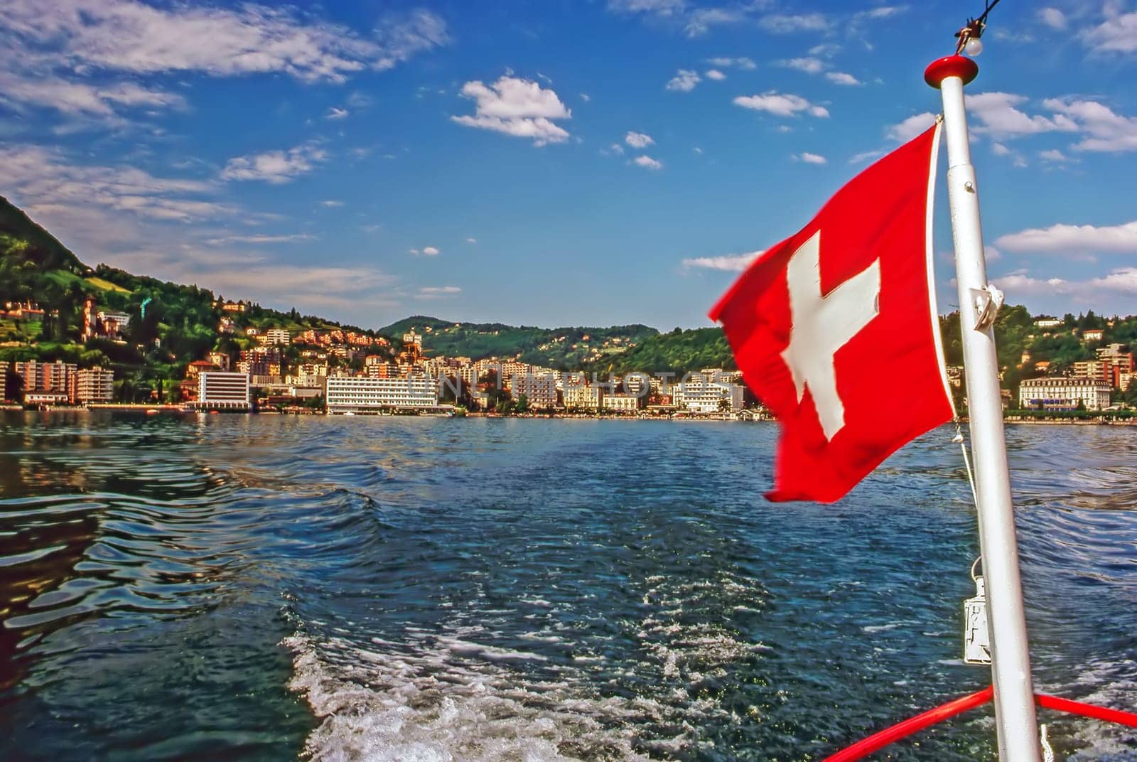 Boat with flag on Lake Lugano, Switzeland