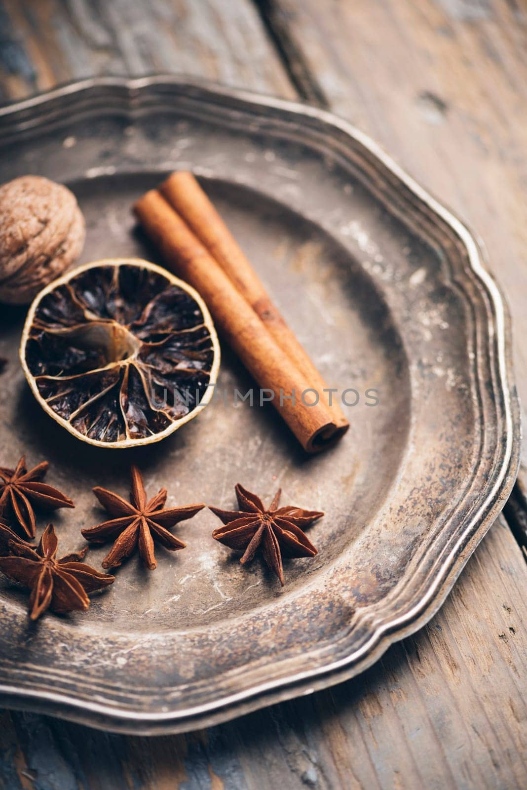 Aromatic spices in rustic silver plate. Winter christmas concept.