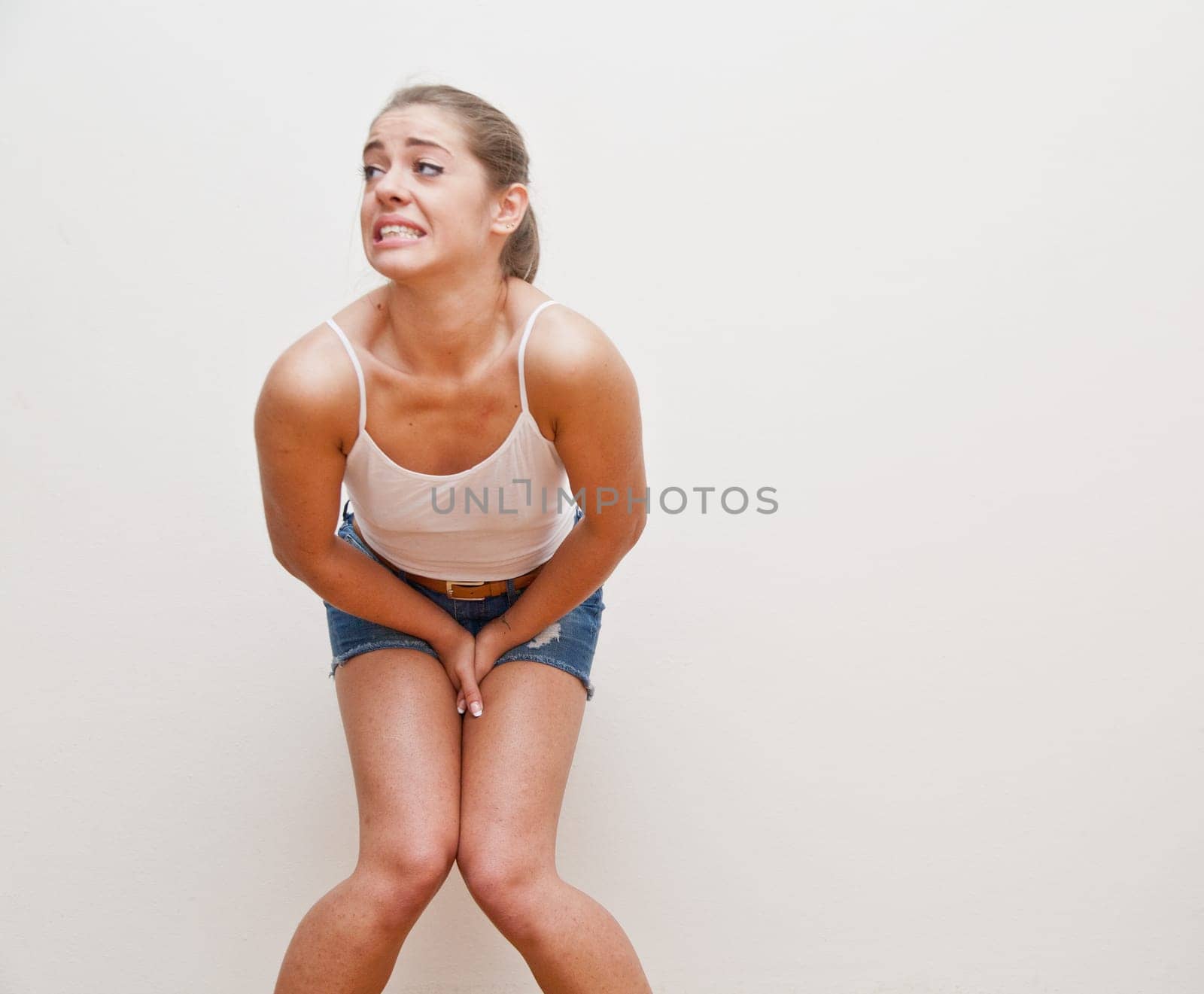 this girl makes the explicit gesture, like babies do, to mean that she needs to go to make pee, to go to bathroom