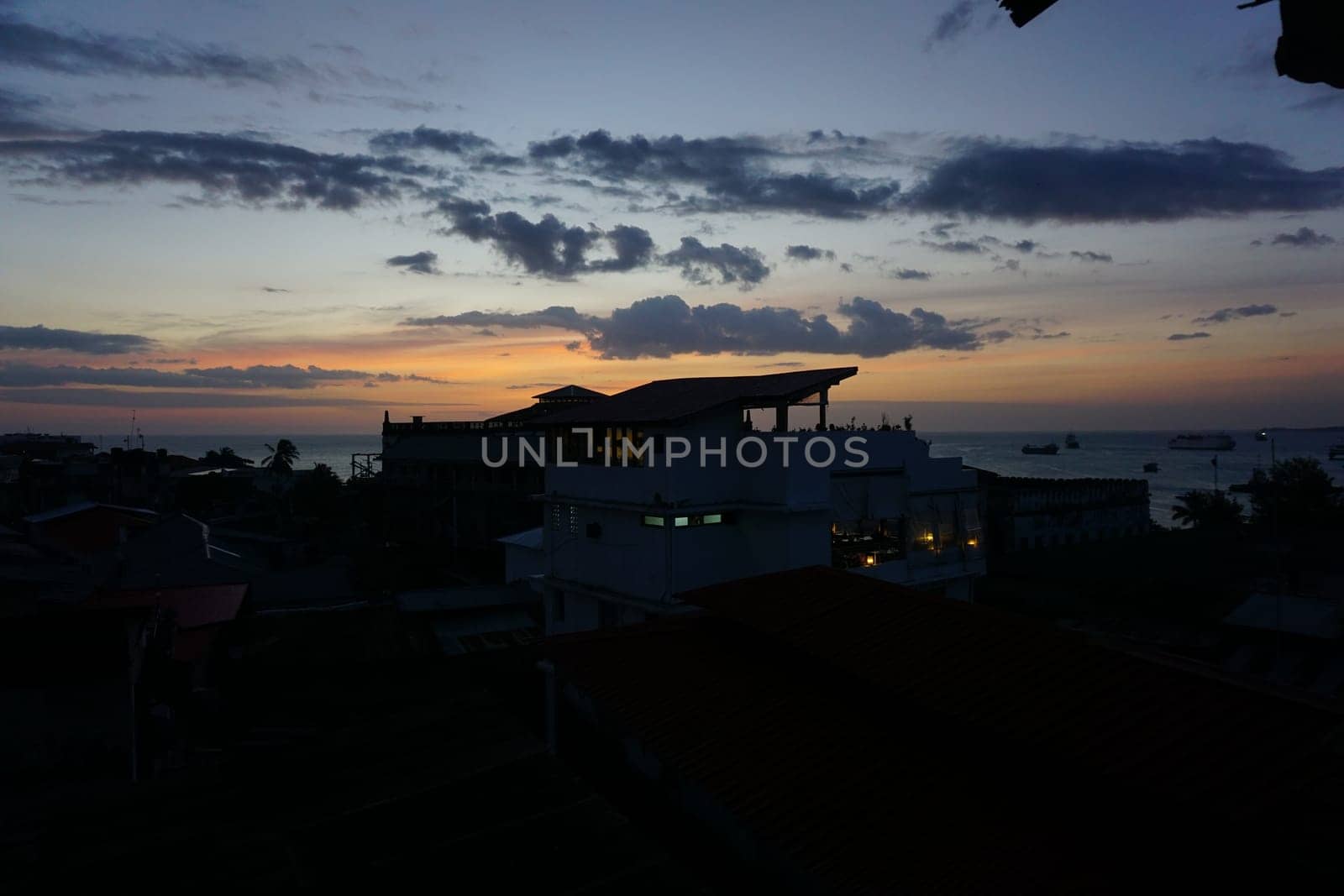 View from a rooftop onto the old town of Stone Town, Zanzibar at sunset, Tanzania 2021