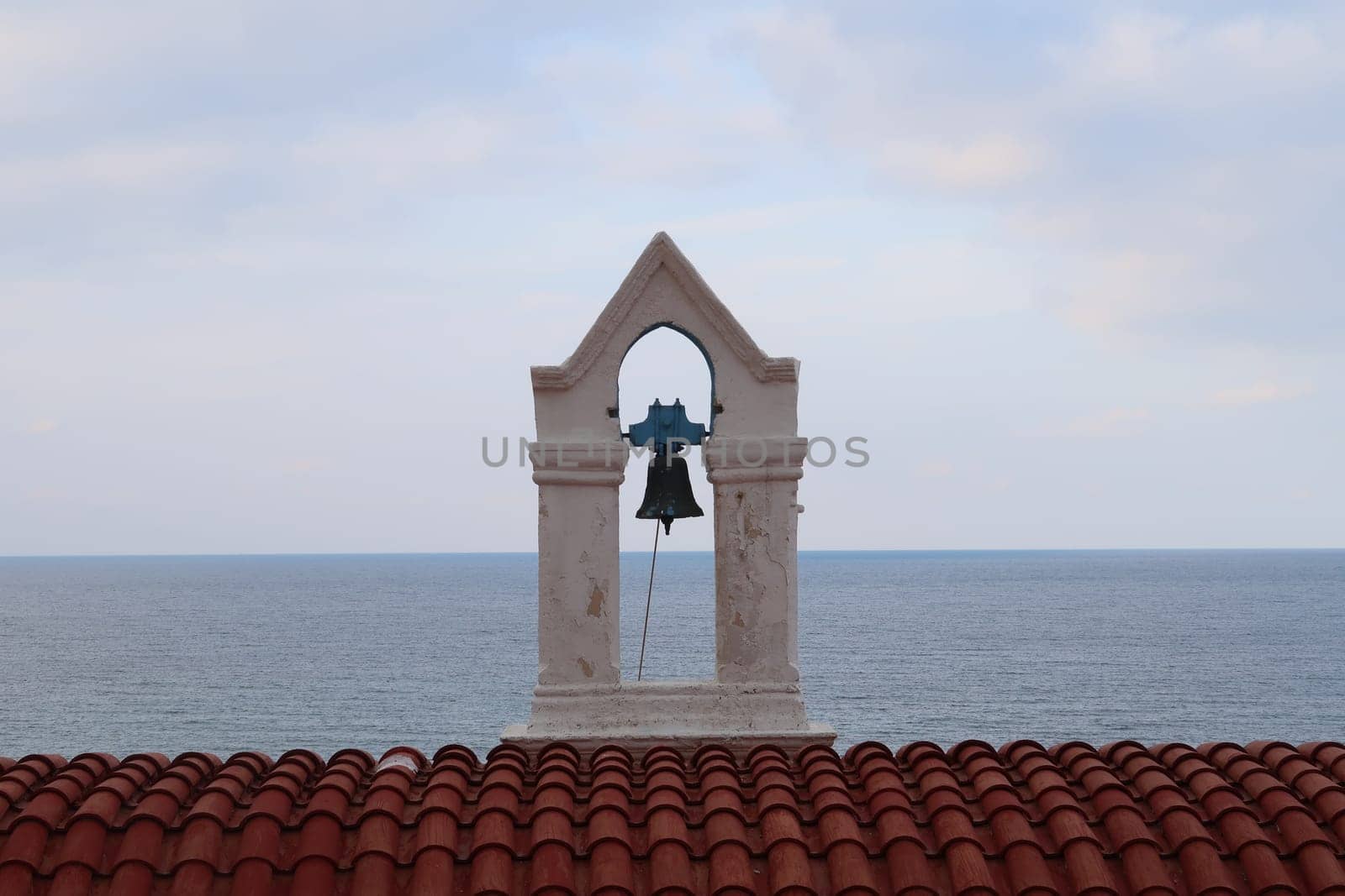 Picturesque bell tower of the Agia Kyriake Church in Chania Crete with the sea in the background, Crete, Greece 2021