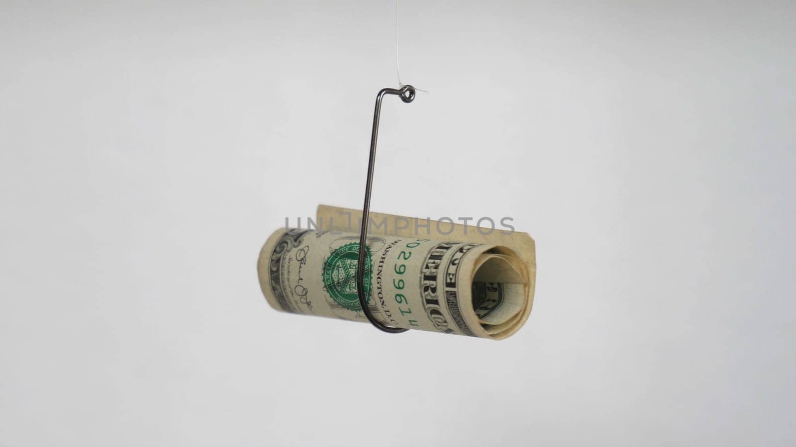 Dollar On A Fishing Hook Isolated On White Background