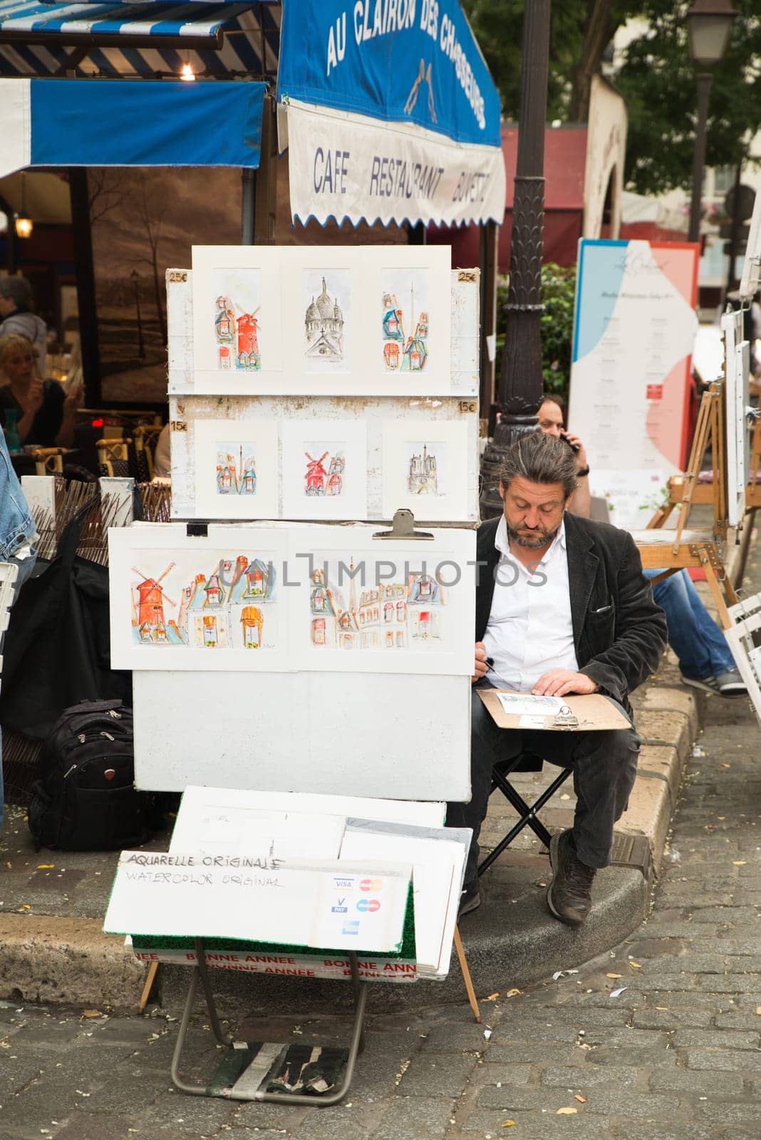 Montmartre Paris, painter at the place du tertre, tourism attraction in France, artists drawing portraits, Paris at the Montmartre on the 04.08.2017