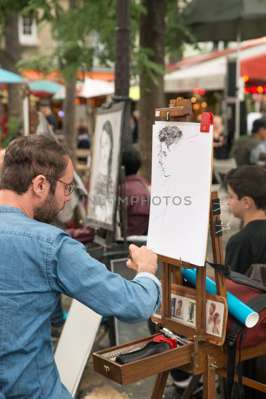 Montmartre Paris, painter at the place du tertre, tourism attraction in France, artists drawing portraits, Paris at the Montmartre on the 04.08.2017