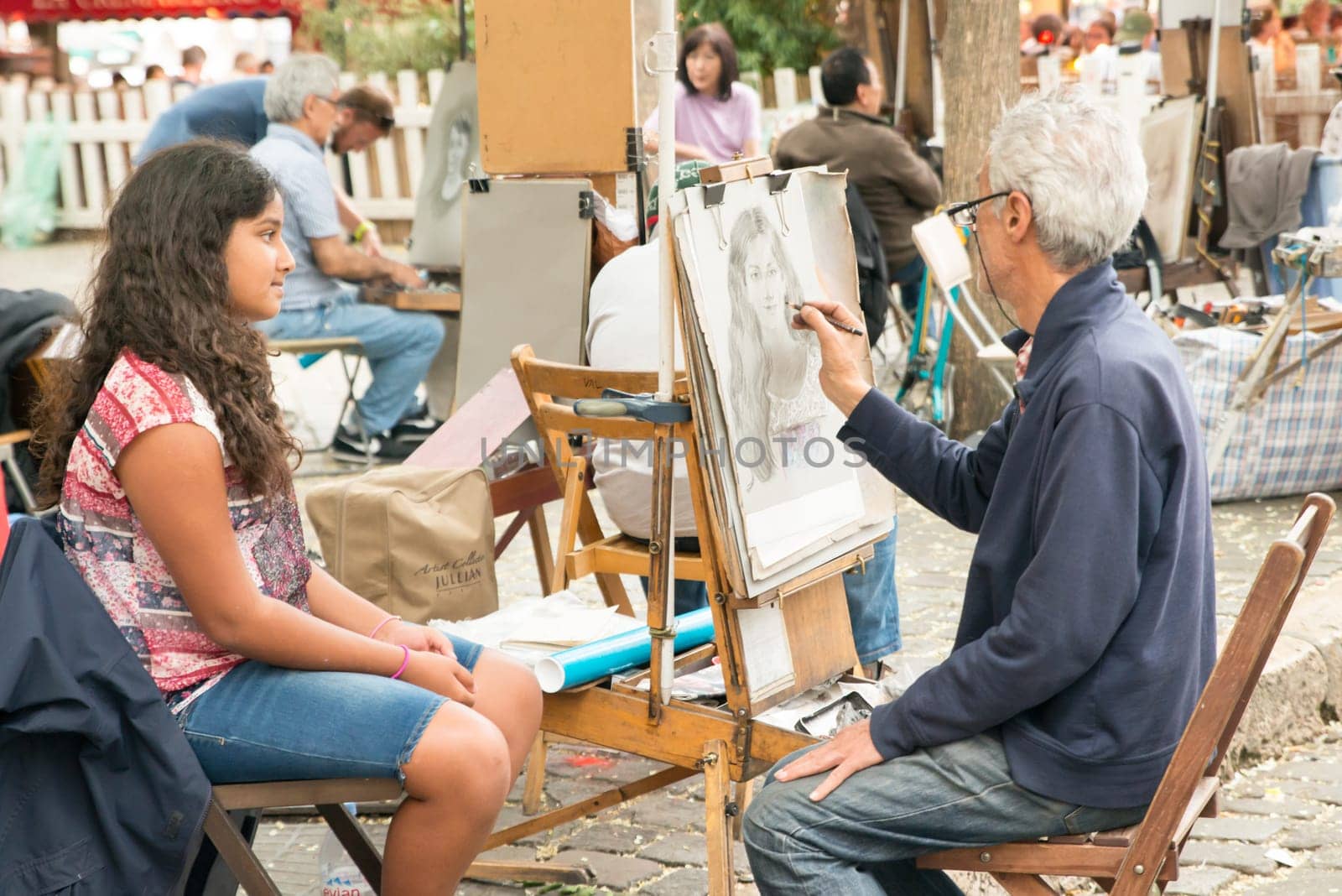 Montmartre Paris, painter at the place du tertre, tourism attraction in France, artists drawing portraits, Paris at the Montmartre on the 04.08.2017