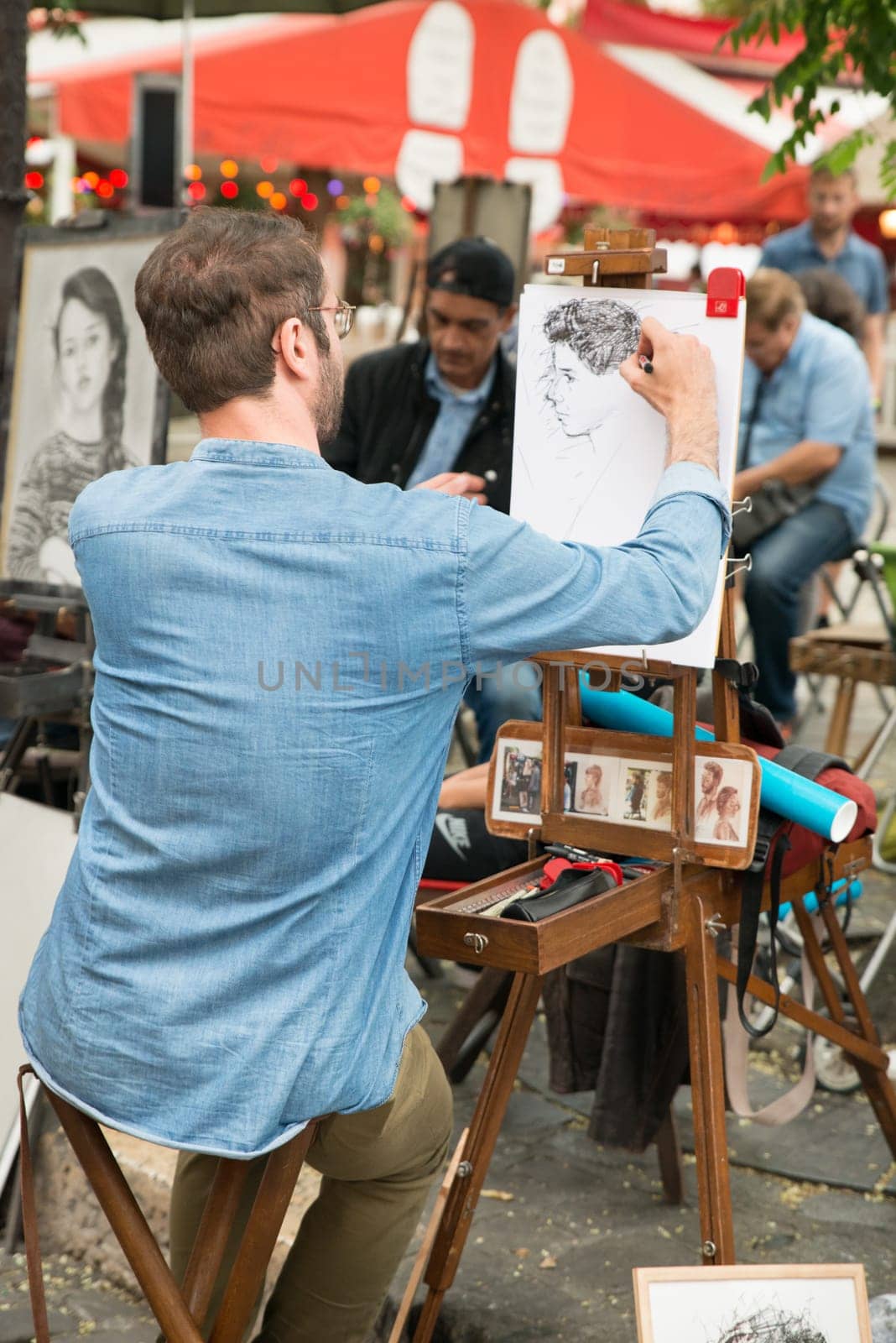 Montmartre Paris, painter at the place du tertre, tourism attraction in France, artists drawing portraits, Paris at the Montmartre on the 04.08.2017