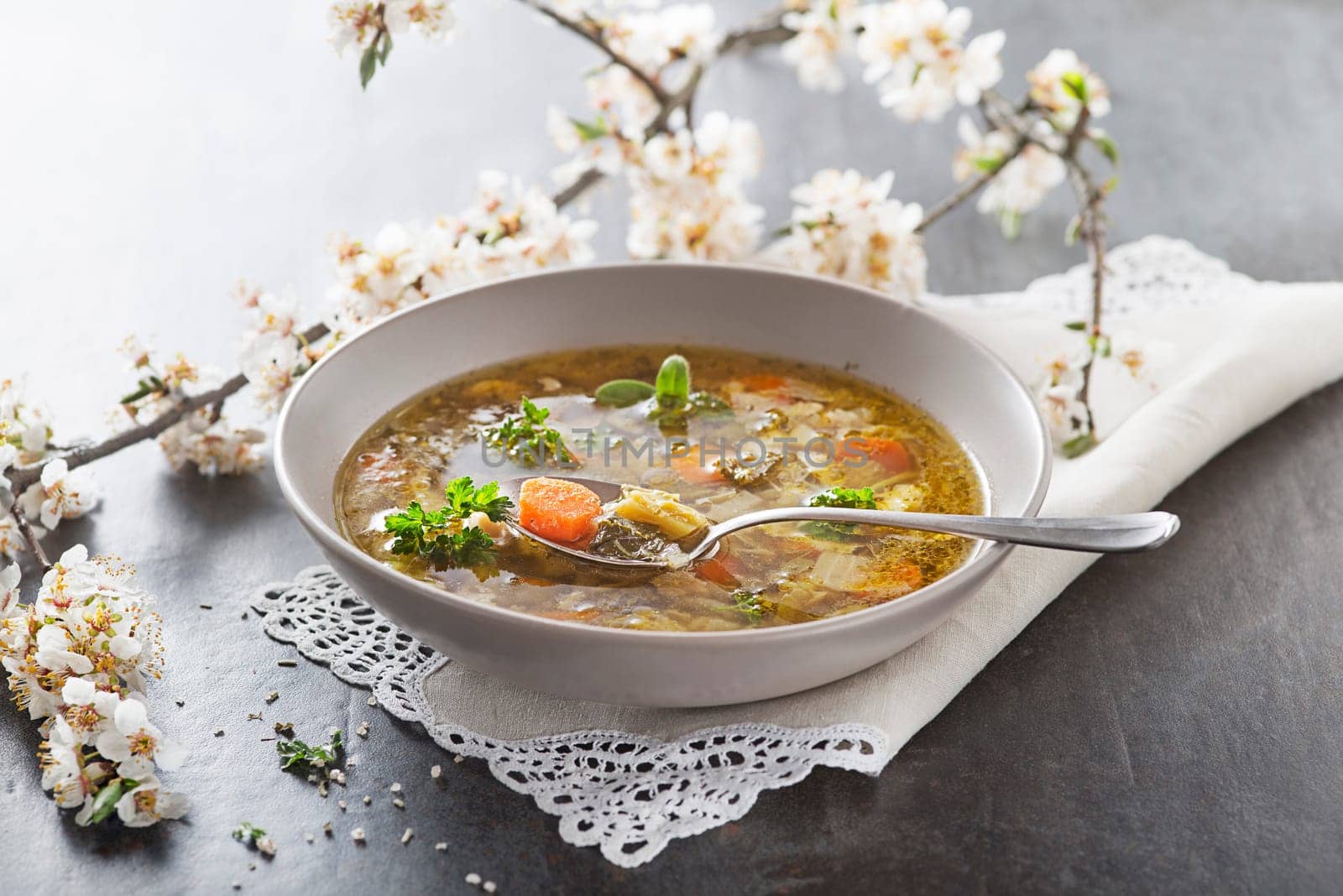 Minestrone soup with fresh vegetable close up. Italian soup with seasonal vegetables. Delicious vegetarian food concept.