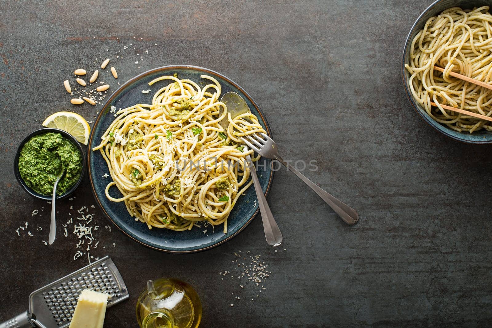 Served hot spaghetti with fresh basil pesto and parmesan cheese