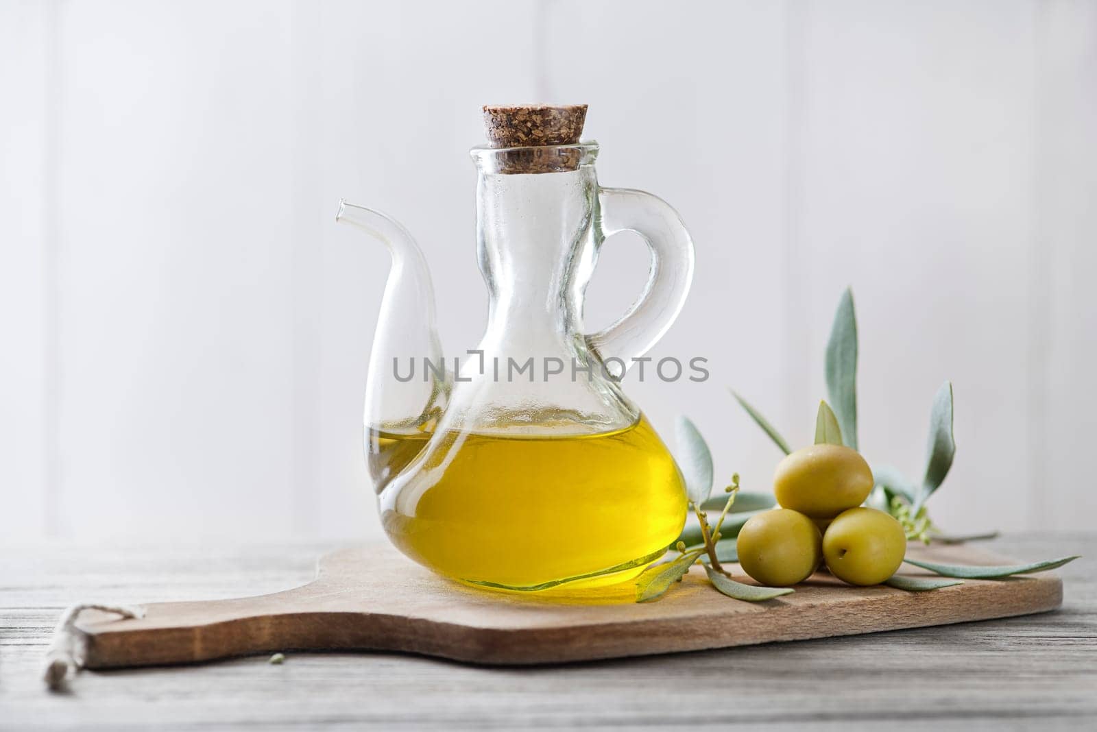 Organic olive oil. Bottle of Extra virgin oil with olives and branch leaves