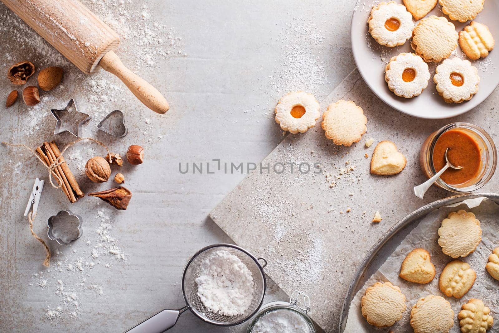 Making and baking cut-out sugar cookies of all shapes and sizes. Holiday, celebration and cooking concept.