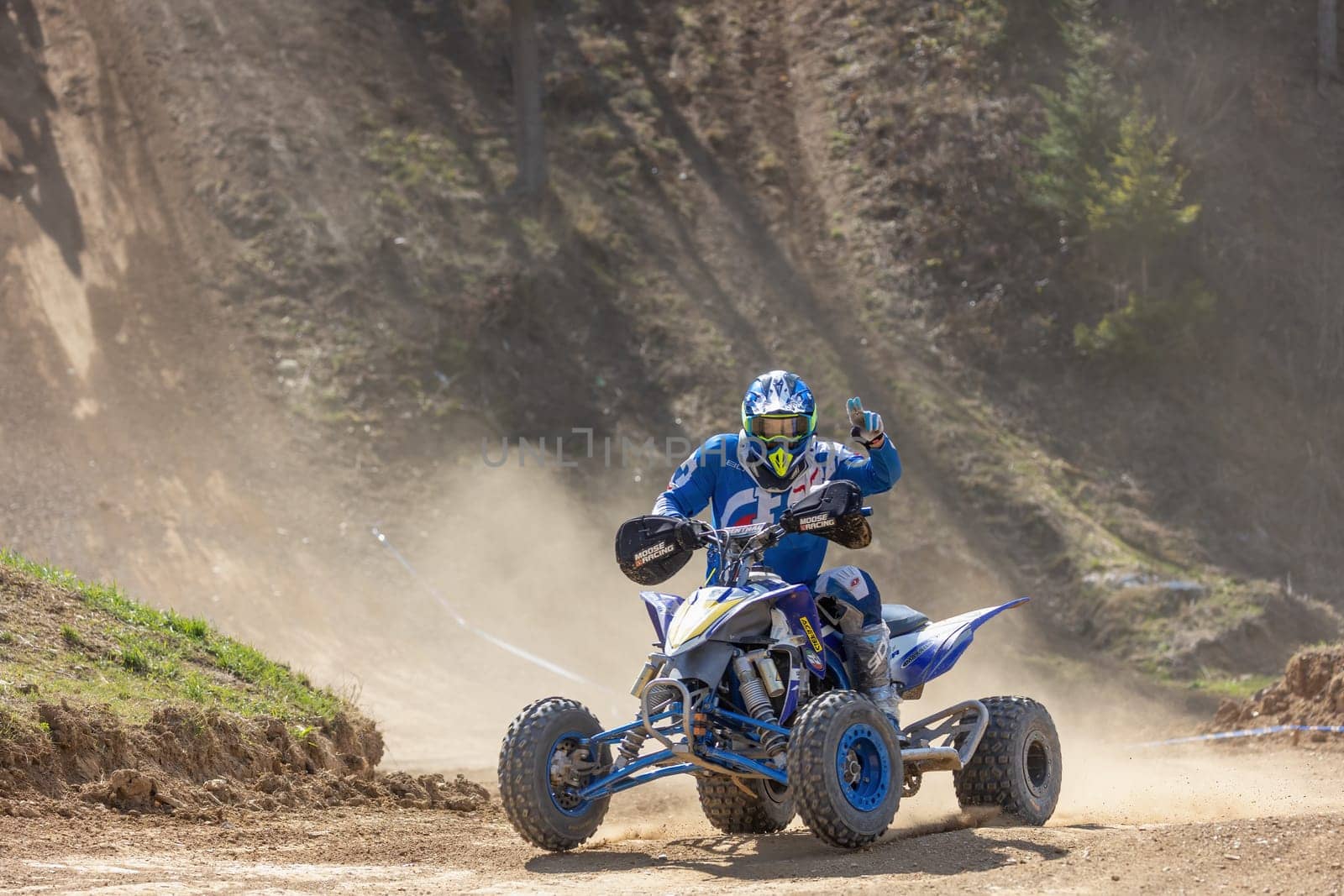MOHELNICE,  CZECH REPUBLIC - APRIL 16, 2022: Rider on a quad bike is posing while driving in International Championship of Czech Republic in Sidecarcross, category Quad on April 16, 2022 in Mohelnice.