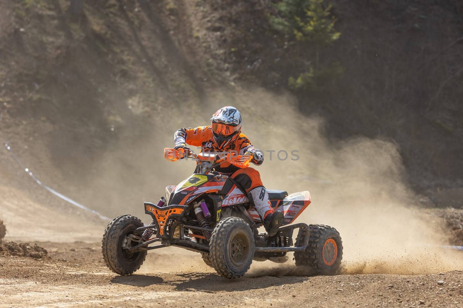 MOHELNICE,  CZECH REPUBLIC - APRIL 16, 2022: Rider on a quad bike is a passing dust turn in International Championship of Czech Republic in Sidecarcross, category Quad on April 16, 2022 in Mohelnice.