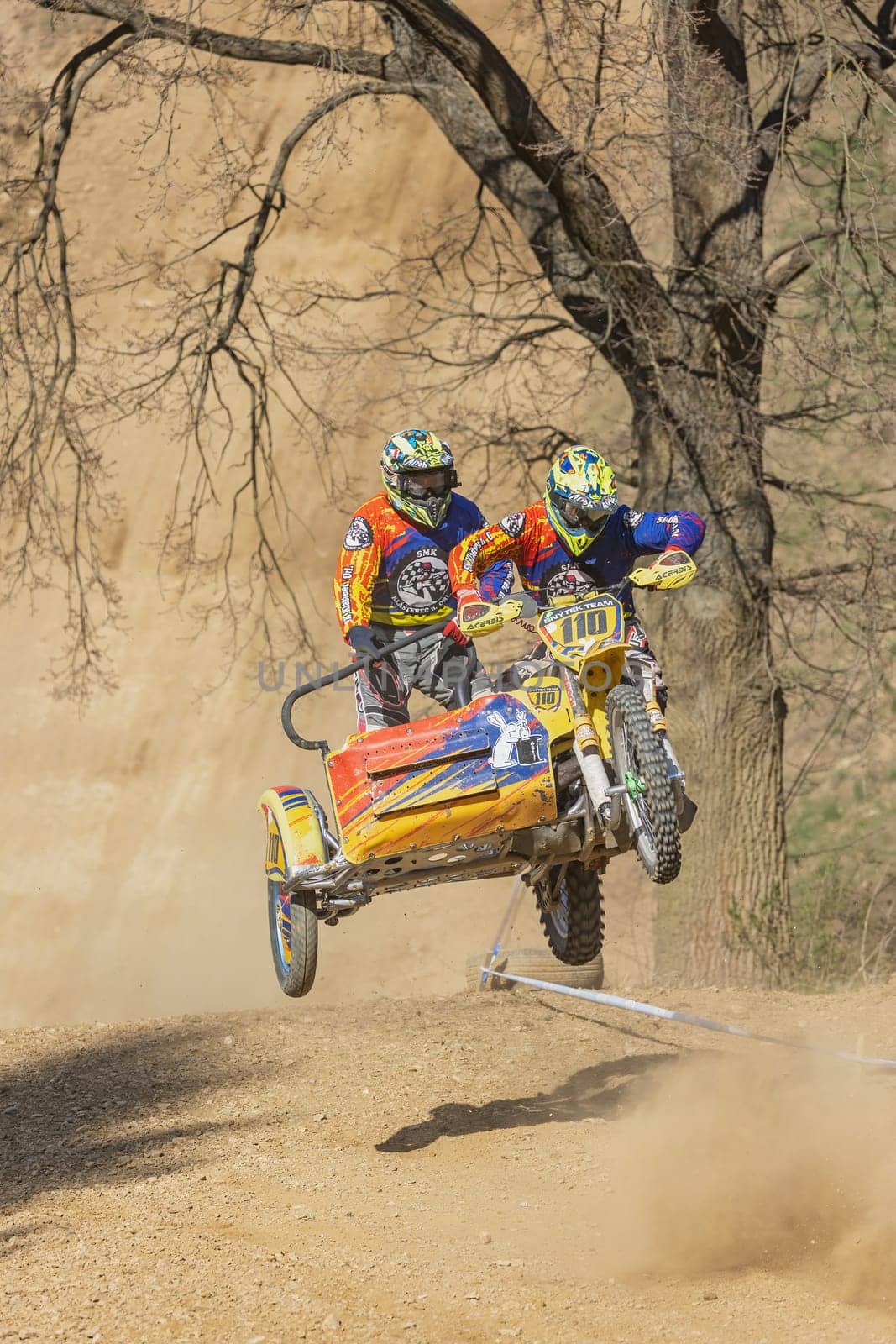 MOHELNICE, CZECH REPUBLIC - APRIL 16, 2022. Vertically photo of sidecacross riders jumping  with motorbike in the "Sidecarcross Championship of Czech Republic"" on April 16, 2022 in Mohelnice."
