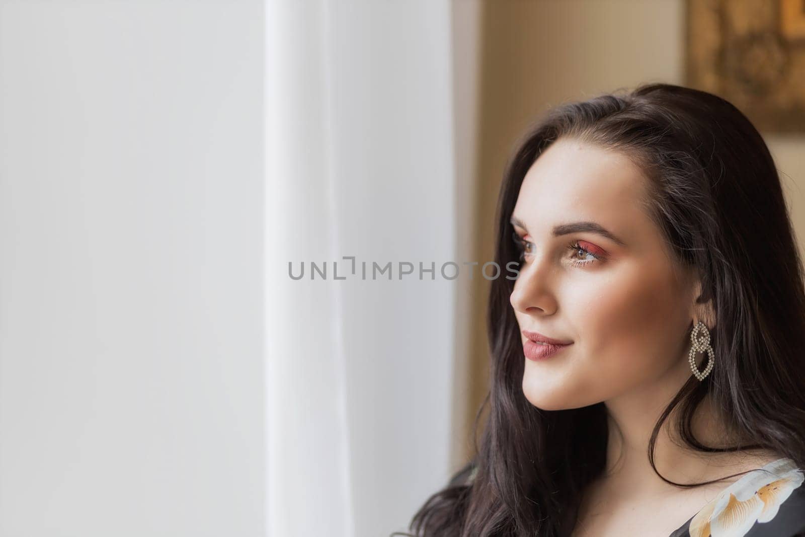 Side view portrait of atractive dark haired young woman. Horizontally.