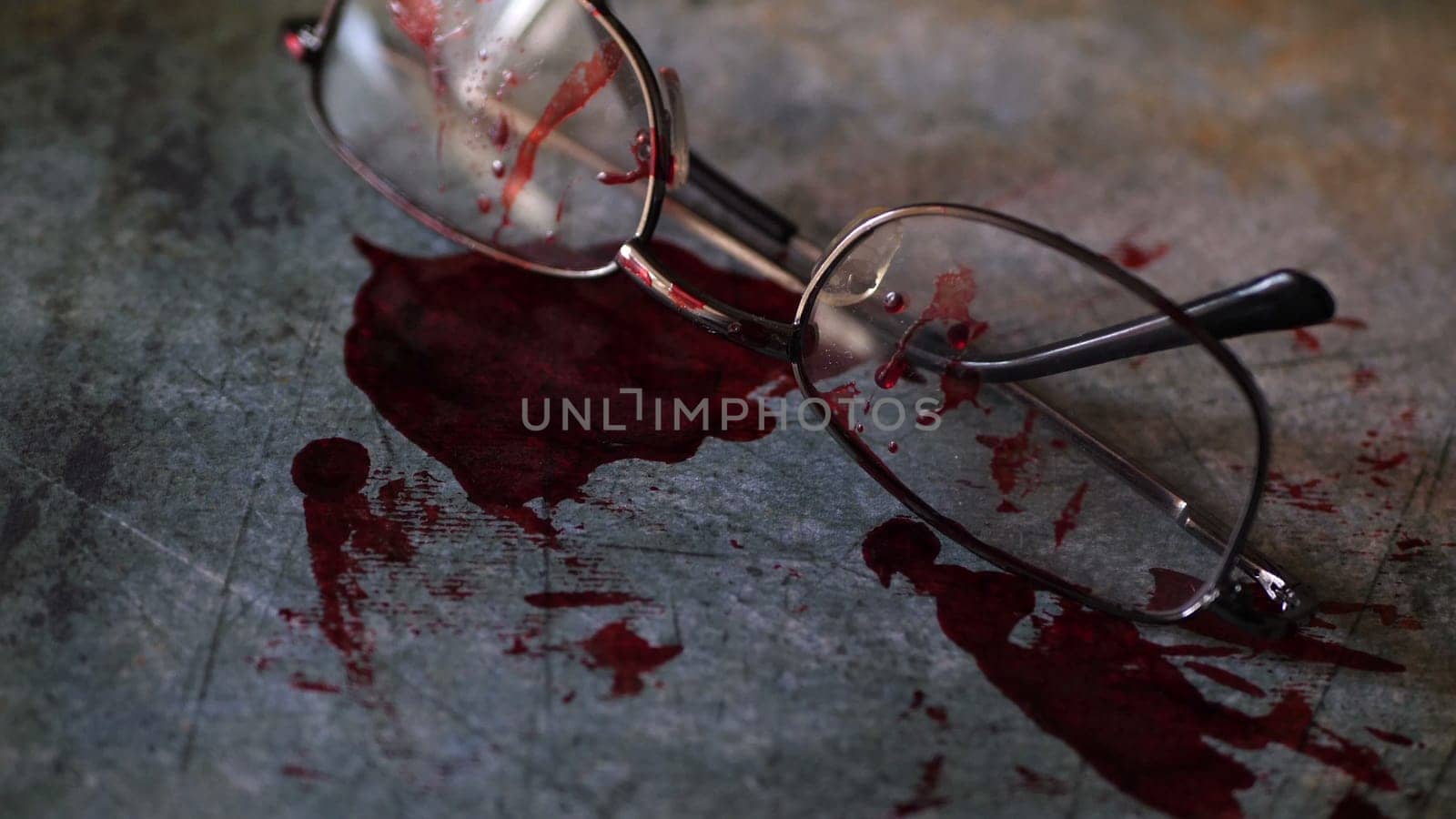 Grungy conceptual crime scene with blood and glasses.