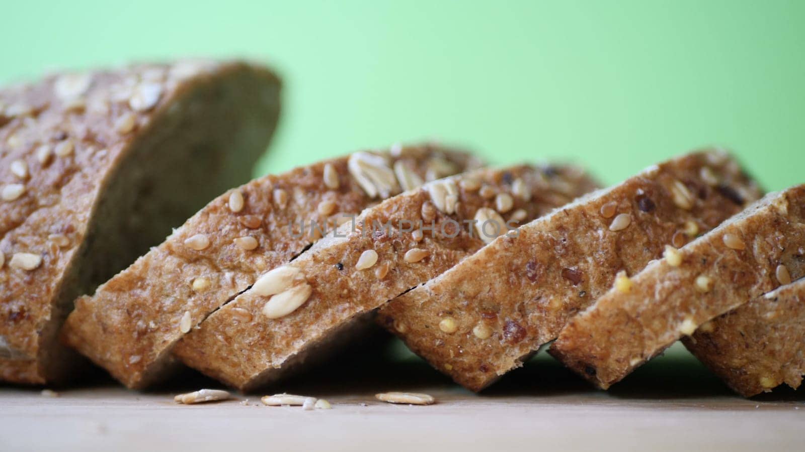 Slicing Whole Grain Bread On Wooden Table.