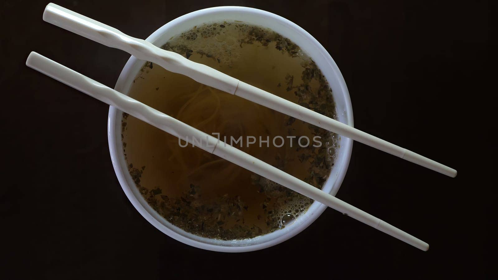 Close up of instant noodles yellow ramen and  Chinese chopsticks,Close up of instant noodles yellow ramen and  Chinese chopsticks