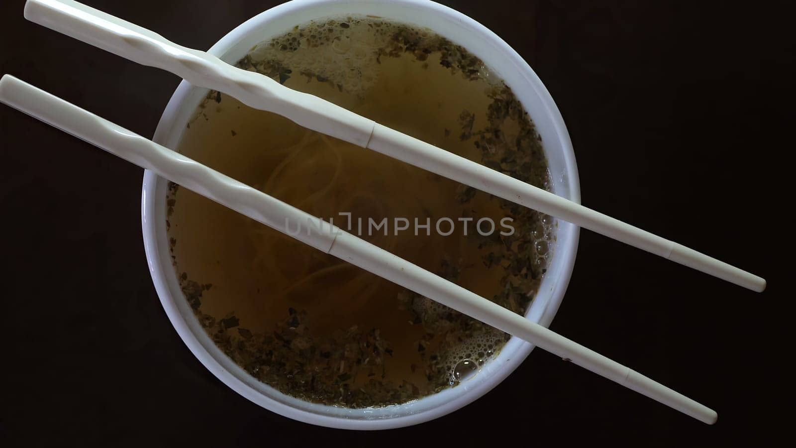 Close up of instant noodles yellow ramen and  Chinese chopsticks,Close up of instant noodles yellow ramen and  Chinese chopsticks