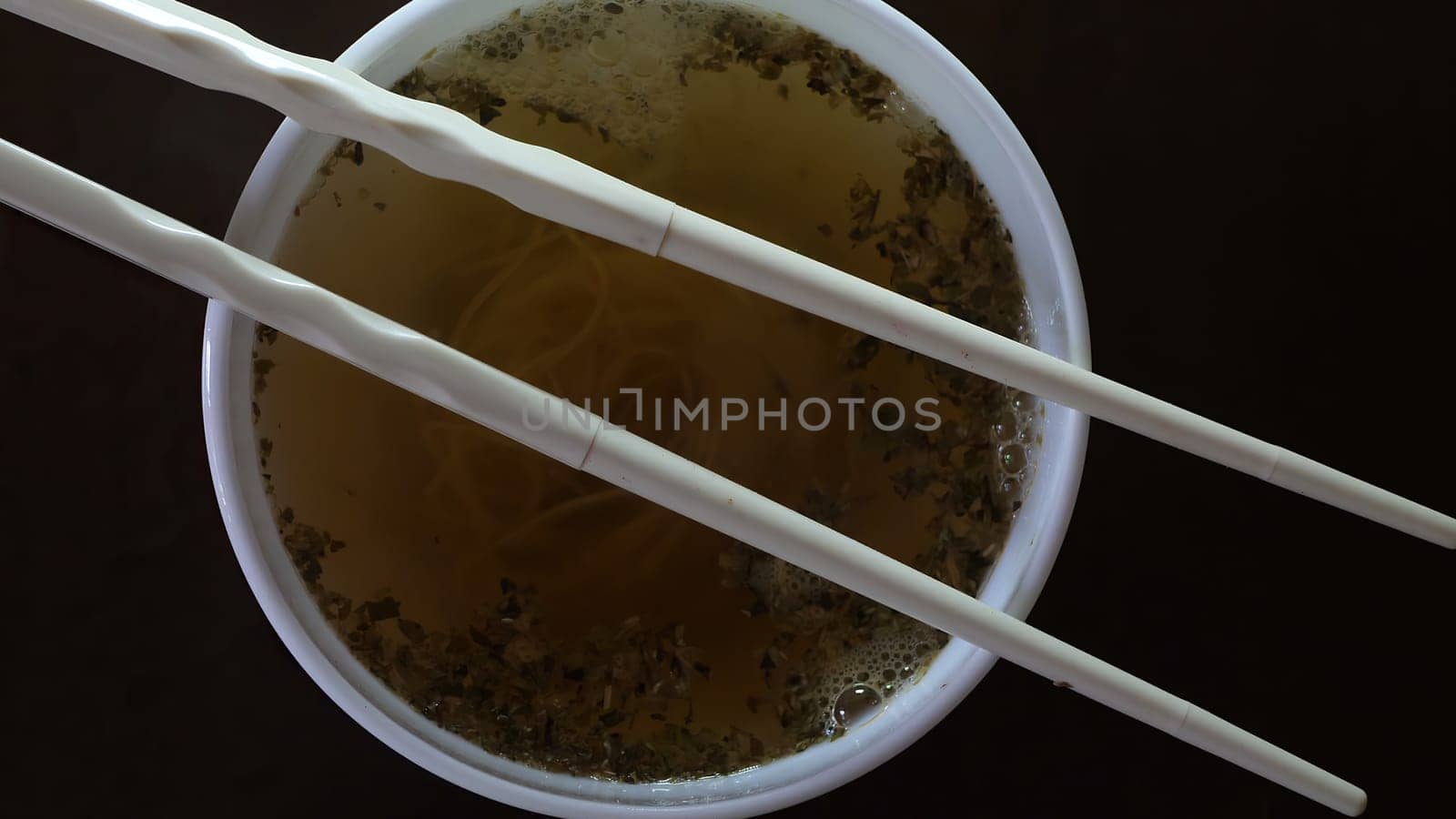 Close up of instant noodles yellow ramen and  Chinese chopsticks,Close up of instant noodles yellow ramen and  Chinese chopsticks