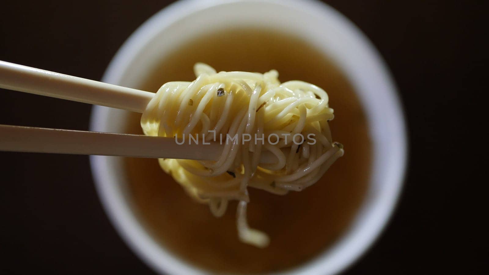 Close up of instant noodles yellow ramen and  Chinese chopsticks