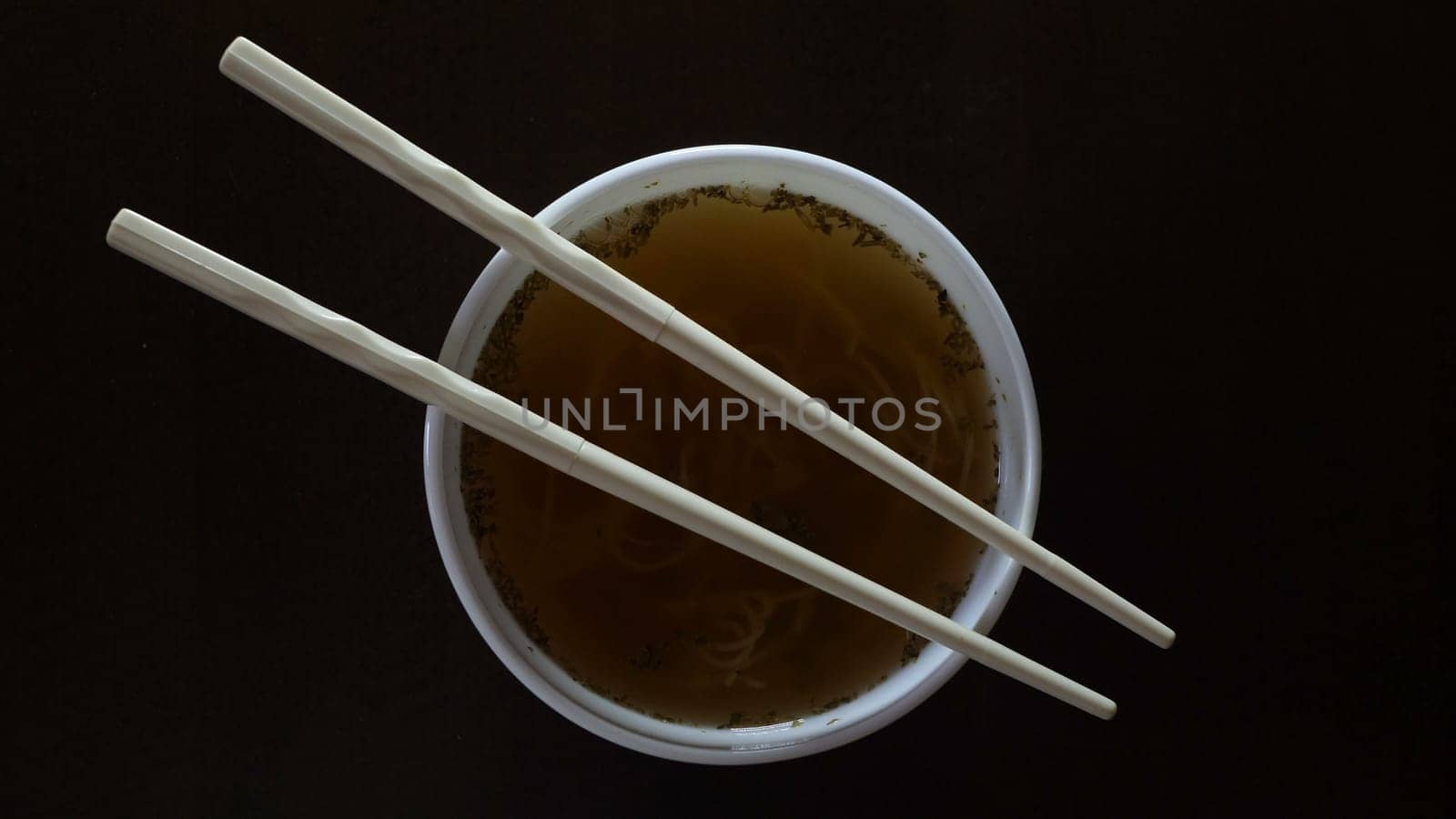 Close up of instant noodles yellow ramen and  Chinese chopsticks