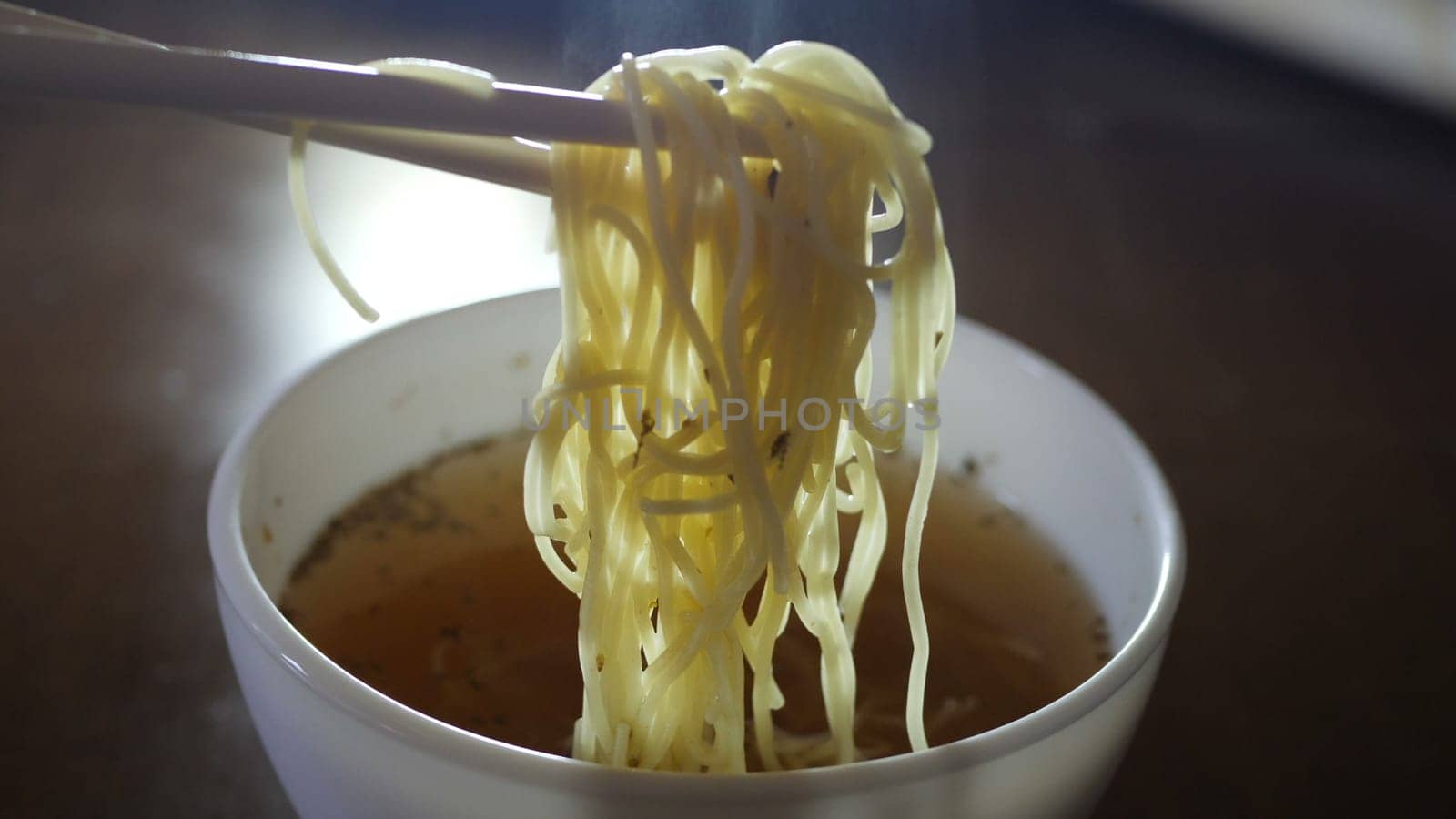 Close up of instant noodles yellow ramen and  Chinese chopsticks