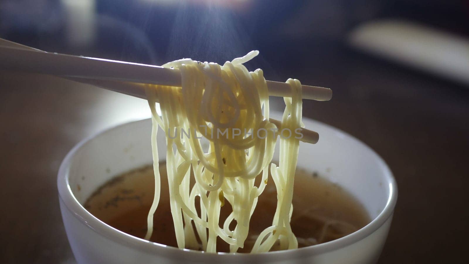 Close up of instant noodles yellow ramen and  Chinese chopsticks