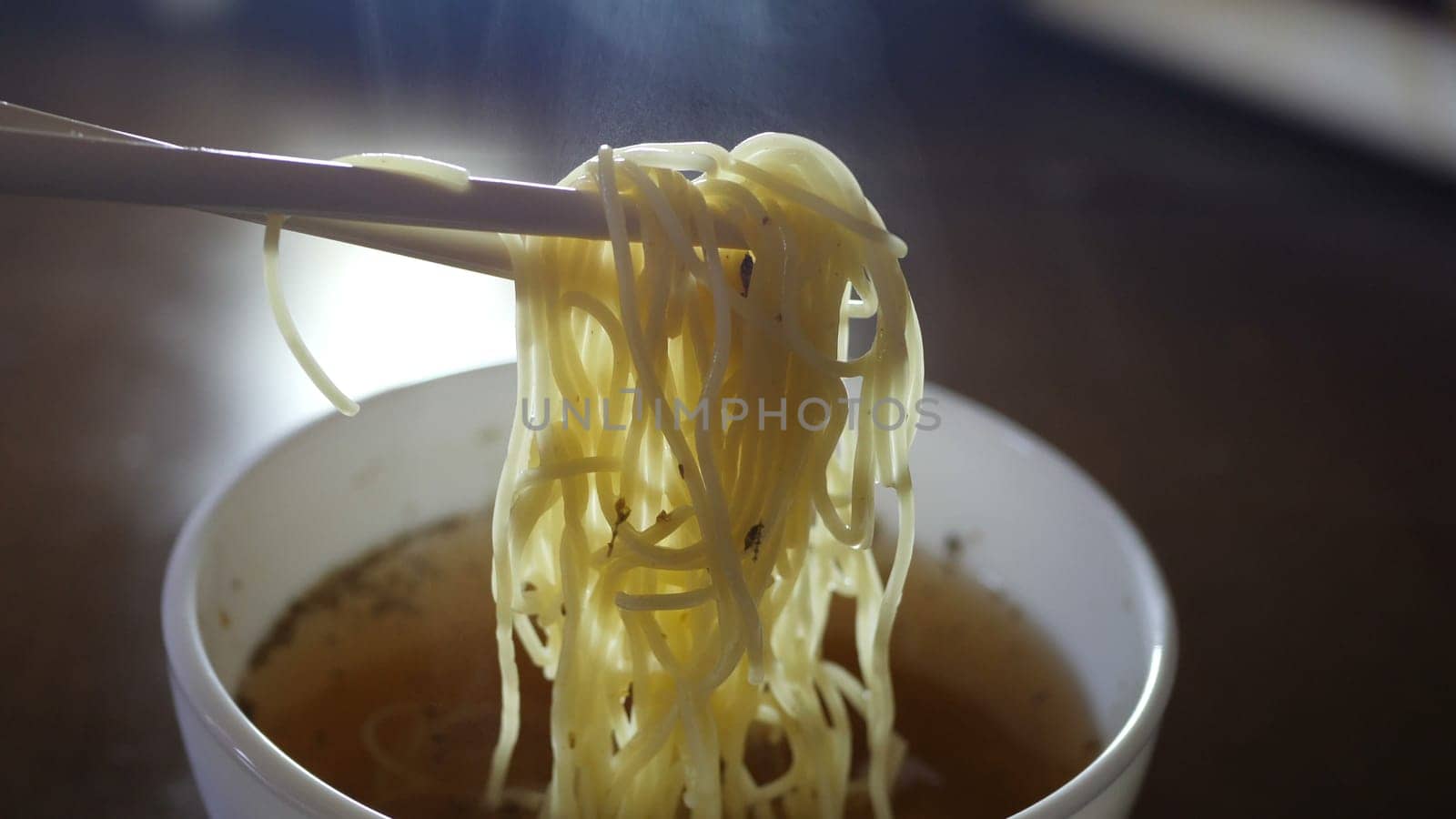 Close up of instant noodles yellow ramen and  Chinese chopsticks