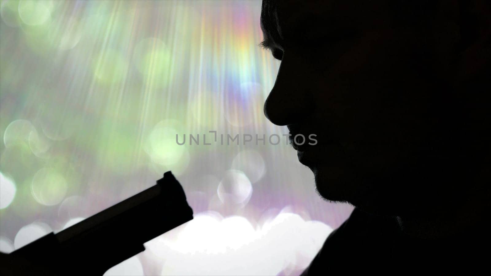 Silhouette Of Serious Male Holding Pistol And Preparing To Kill Himself Suicide.