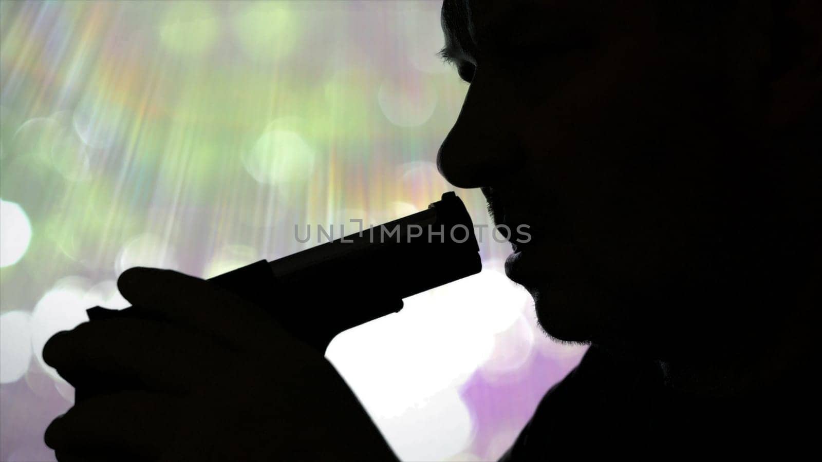 Silhouette Of Serious Male Holding Pistol And Preparing To Kill Himself Suicide.