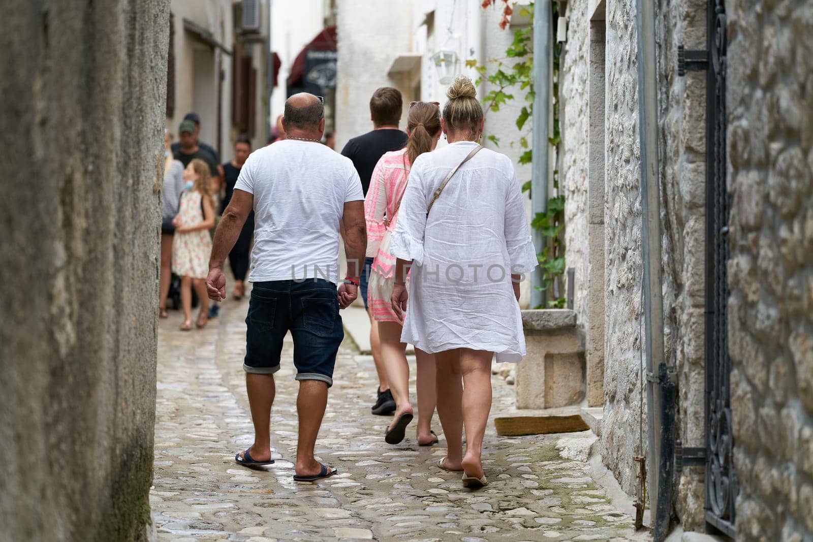 Tourists walking through the historic old town of Krk in Croatia