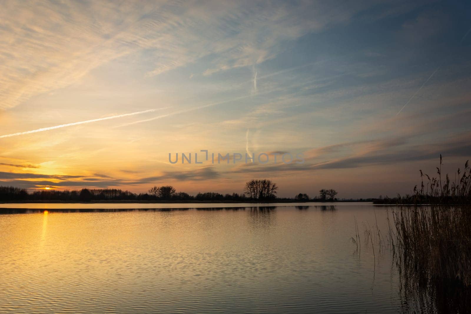 Sunset and clouds over a calm lake, Stankow, Poland