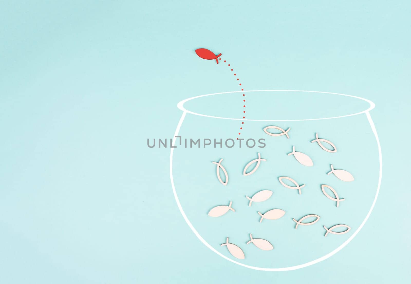 One fish is the leader of the group, leadership and teamwork concept, be a winner, success and start up in business, follow a new idea, fishes in a aquarium jump to freedom