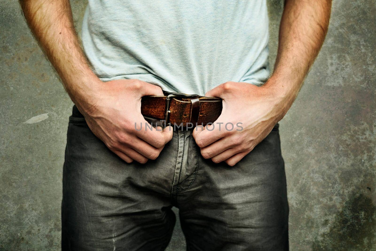 Man in jeans with fashionable leather belt