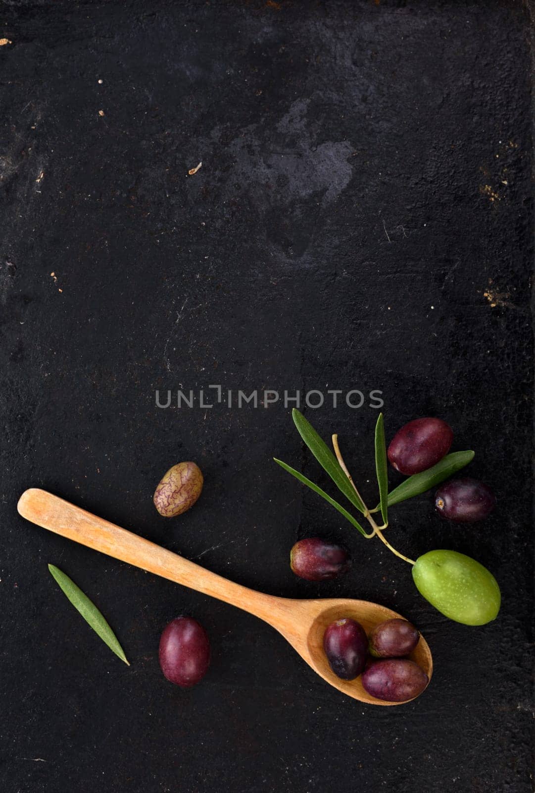 Fresh olives on black rustic background