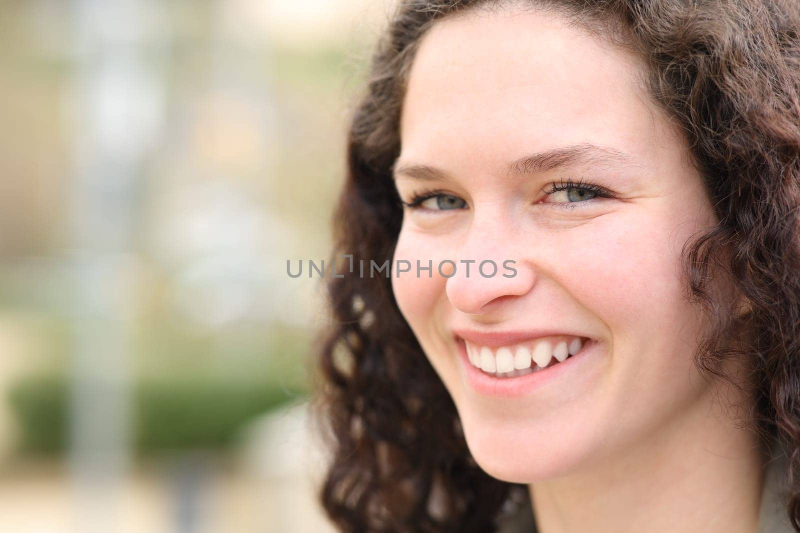 Happy woman smiling at camera in the street