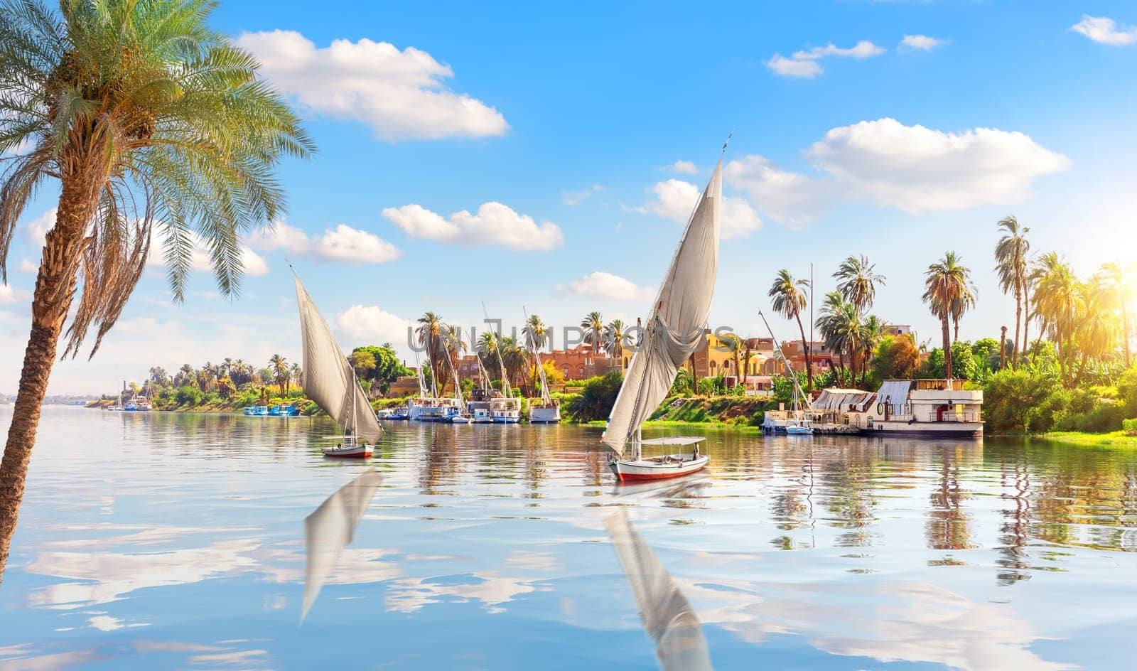 Sailboats in the Nile and the view of Luxor, Egypt.