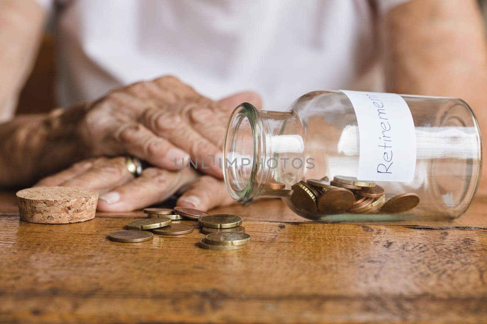 Elderly retired woman and her savings in a jar