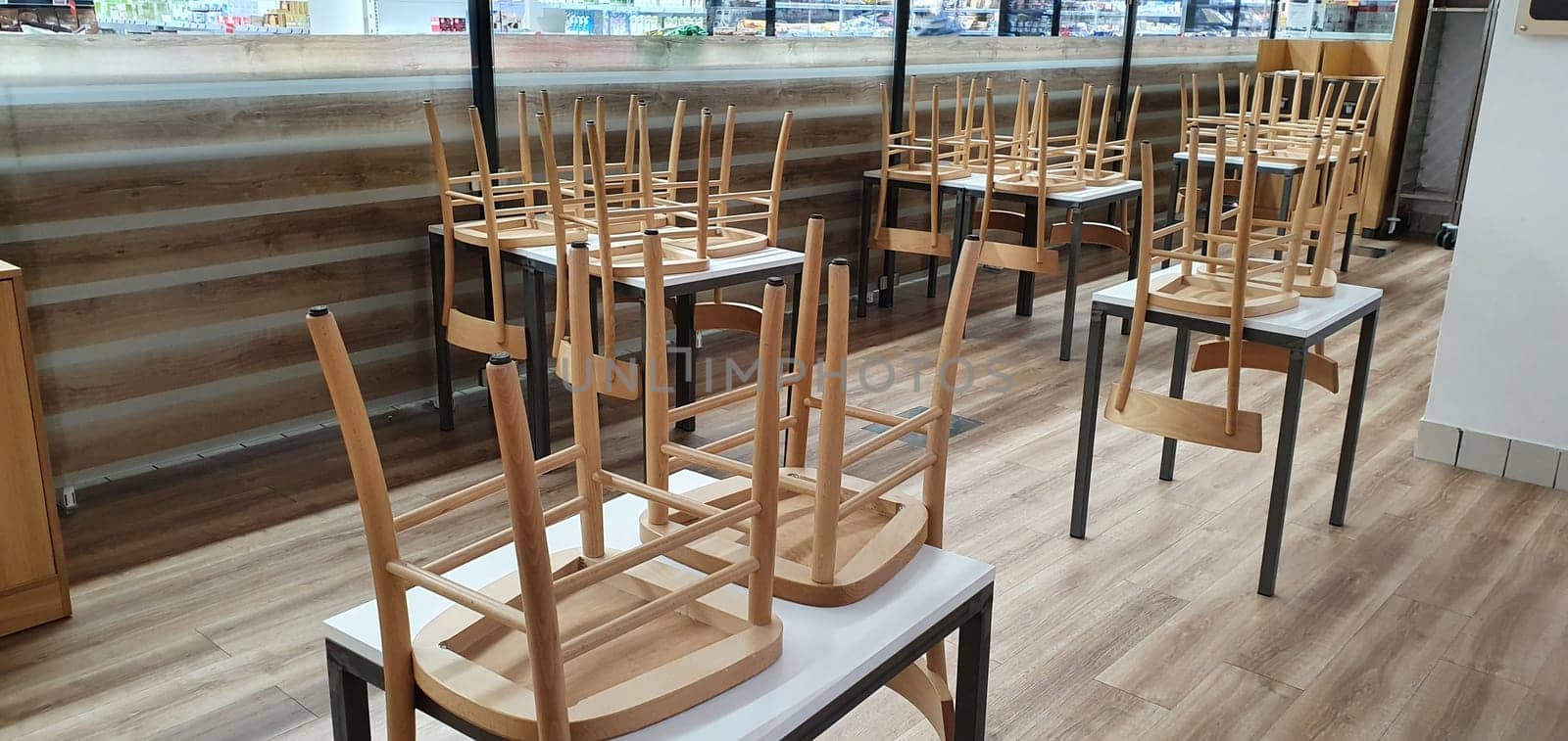 empty food and restaurant client-side area with chairs upside-down for quarantine and lockdown in COVID-19 times